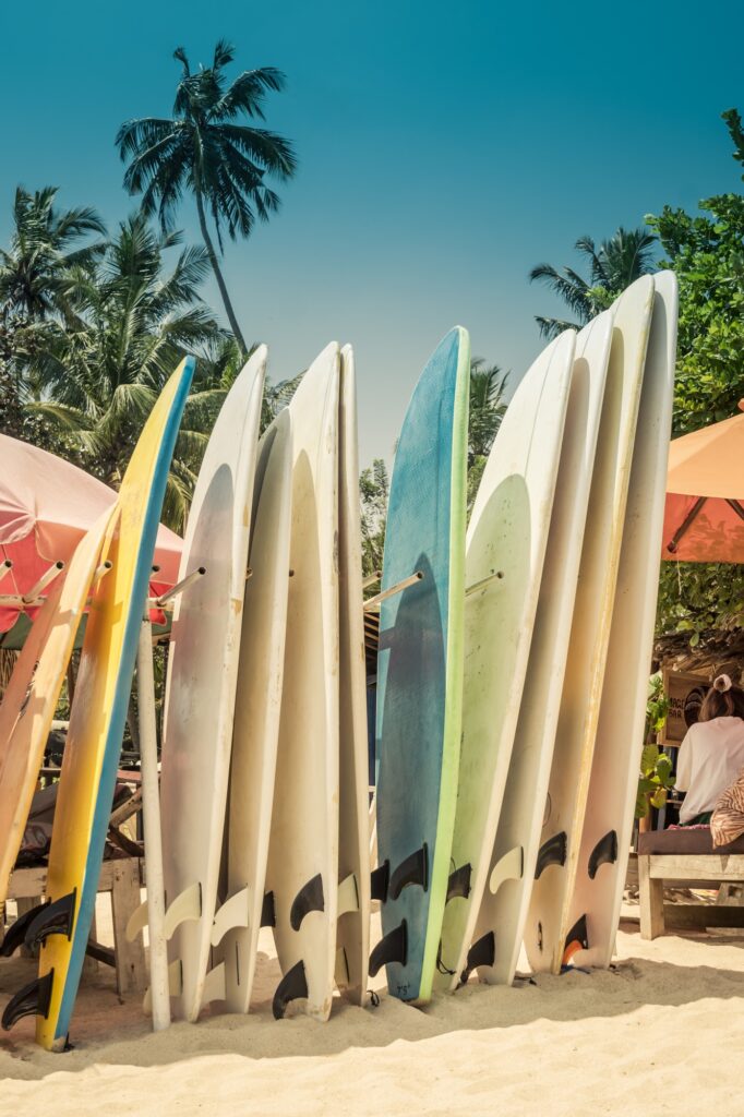 Surf boards in stack for rent by ocean on seminyak beach.