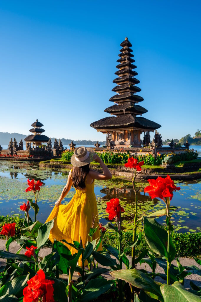 Young female tourist relaxing and enjoying the beautiful view in Bali